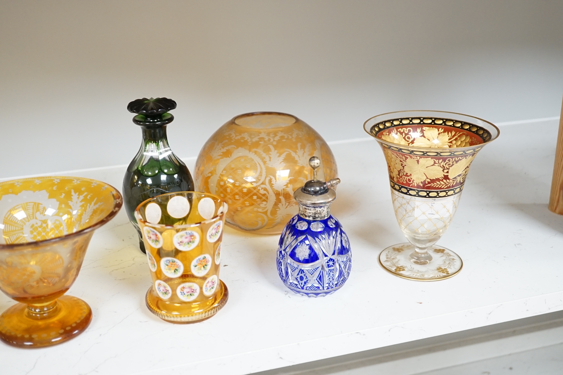 A collection of mostly Bohemian amber flashed cut glassware to include dishes, glasses and a silver topped atomiser, largest 22cm in diameter. Condition - mostly fair